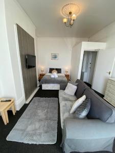 a living room with a couch and a bed at Farina No1, Sea view studio sleeping 2 guests in Bridlington