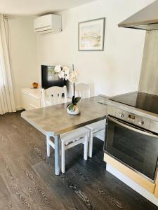 a kitchen with a table and a stove at BUNGALOW 60 M2 in Roquebrune-sur-Argens