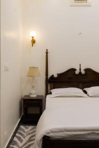 a bedroom with a bed and a lamp on a table at Heart of the City Homestay by Rashmi in Jaipur