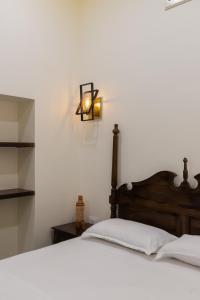 a bedroom with a bed with a light on the wall at Heart of the City Homestay by Rashmi in Jaipur
