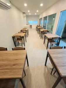 a row of tables and chairs in a room at The Guest Chang Moi Hotel in Chiang Mai