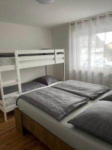 a bedroom with two bunk beds and a window at Casa Estella in Rust