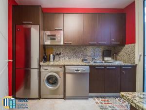 a kitchen with a refrigerator and a washing machine at Casa Anima en Platja d'Aro in Platja d'Aro