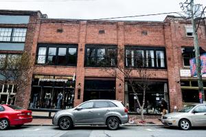 two cars parked in front of a brick building at 80 Lex 203 Eclectic Industrial Apt in Asheville