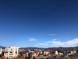 a city skyline with buildings and a blue sky at TIF Studio in Râmnicu Vâlcea