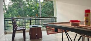 a room with a table and a chair and a window at Sugamya Farm Guesthouse in Sāgar