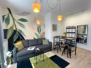 a living room with a couch and a table at URBAN APARTMENTS PREMIUM No 12A, Free Parking, Self Check-in in Chorzów