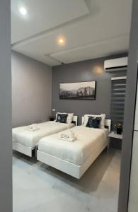 a bedroom with two beds and a painting on the wall at Anavada Apartment - Davao City in Davao City