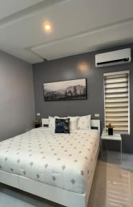 a bedroom with a large white bed in a room at Anavada Apartment - Davao City in Davao City