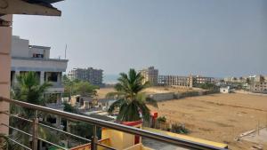a view of the beach from a balcony of a building at Hotel Aradhya Puri Sea View Room - Luxury Stay - Best Hotel in Puri in Puri