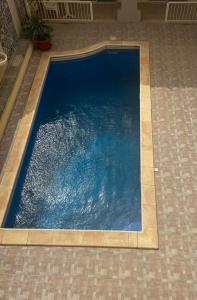 a swimming pool in the floor of a house at Phase Guesthouse in Xewkija