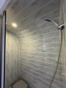 a shower in a bathroom with a wall at KAYACIK TESİSİ in Dalaman