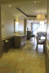 een keuken en eetkamer met een tafel en stoelen bij ALMADIAFAH APARTMENT - المضيفة للوحدات الفندقيه in Mansoura