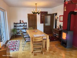 a living room with a table and a wood stove at CasaLucía - hometel in Puchberg am Schneeberg