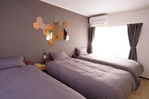 Letto o letti in una camera di Lino下伊福 岡山駅車で5分 無料駐車場 レストラン徒歩圏内多数