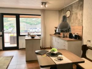 a kitchen with a table and a counter top at Mosel-Appartements Nehren in Zell an der Mosel