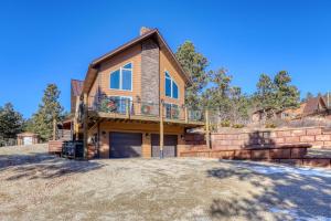 a house with a balcony and a garage at Rocky Ridge Lodge in Lead