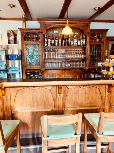 a bar with two chairs and a counter at Hotel zur Post in Schalksmühle