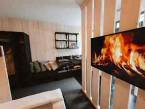 a living room with a large fire in the wall at Horská Chata pod Soliskom in Štrbské Pleso