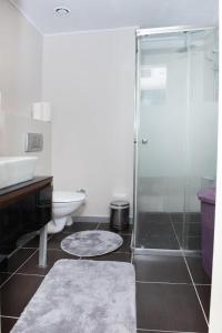 a bathroom with a shower and a toilet and a sink at Ataşehir Residance 2+1 in Istanbul