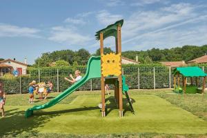 a group of children playing on a playground at maison COSY LES FORGES in Les Forges