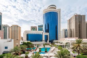 a view of a city skyline with a blue building at Le Royal Meridien Abu Dhabi in Abu Dhabi