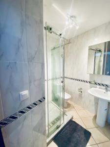 a bathroom with a glass shower and a sink at Cabo Dream Apparthotel in Cabo Negro