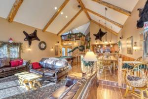 a living room with a couch and a table at Rocky Ridge Lodge in Lead