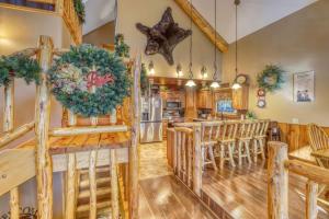 a kitchen and dining room with a christmas wreath on the wall at Rocky Ridge Lodge in Lead