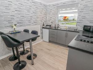 スウォンジーにある48 Gower Holiday Villageのテーブルとカウンタートップのあるキッチン