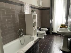 a bathroom with a tub and a toilet and a sink at B&B Home XIX in Narni