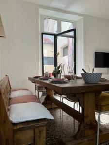 uma sala de jantar com uma mesa de madeira e uma janela em Nature & Médiéval, gîte de charme 4 étoiles em Largentière