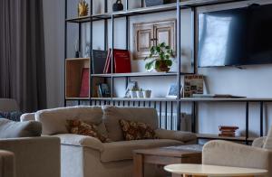 a living room with a couch and a table at Alliance Hotel in Tbilisi City