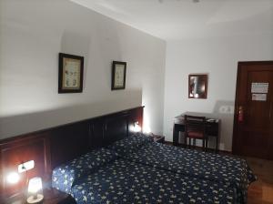 Postel nebo postele na pokoji v ubytování Hostal San Cayetano