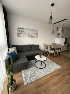 a living room with a couch and a table at SUNNY STUDIO AZUR in Saints Constantine and Helena