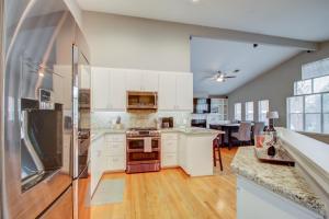 a large kitchen with white cabinets and a table at Upscale Retreat Near NRG/Med Ctr in Houston