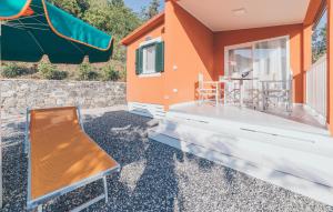 a bench sitting on the front of a house at Gorgeous Home In Deiva Marina With Wifi in Deiva Marina