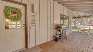 a covered porch with a door and a grill at Circle 4 Cabin - Unit 2 in Bend