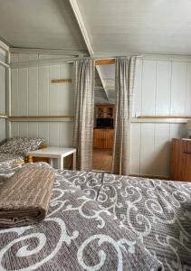 a bedroom with a bed with a patterned bedspread at Splav ANDJELA Perucac in Perućac