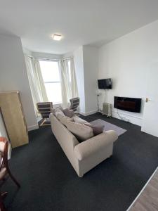 a living room with a couch and a tv at Farina No4, Sea view apartment sleeping 4 guests in Bridlington