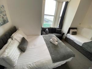 a bedroom with a bed with a towel on it at Farina No4, Sea view apartment sleeping 4 guests in Bridlington
