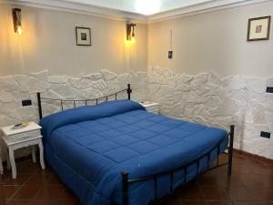 a bedroom with a bed and a stone wall at CASABELLA in Vieste