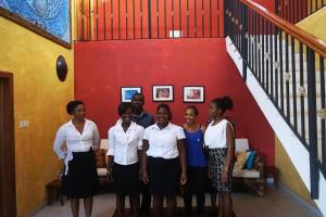 a group of people standing in front of a red wall at Accra Royal Castle Apartments & Suites in Kwabenya +55 photos
