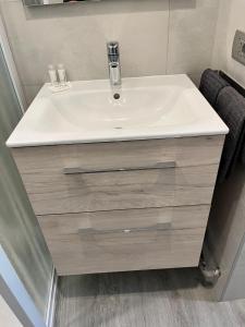 a bathroom with a white sink and a mirror at Emma House in Bellano