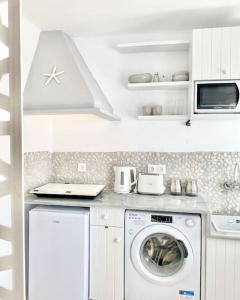 a kitchen with a washer and a washing machine at Cabarnus House in Parikia +37 photos