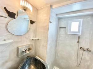 a bathroom with a sink and a mirror at Cabarnus House in Parikia