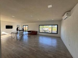 a large living room with a table and a couch at Departamento Amoblado de lujo! in Pilar