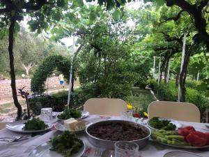 a table with a plate of food on it at Guest-house Grandfatherfarm1 in Durrës
