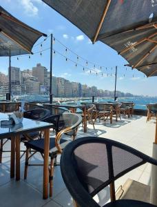 a row of tables and chairs on a patio at خان العطلات in King Mariout