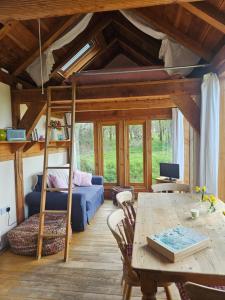 a living room with a bunk bed and a table at Log Cabin at The Old Summer Dairy Glastonbury in Somerton